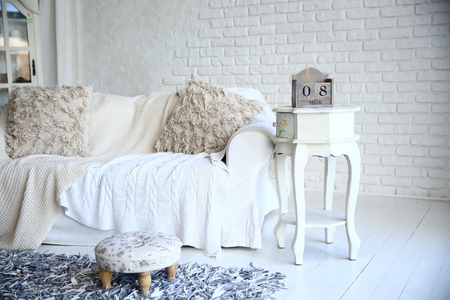 white sofa and nightstand with changeover calendar in a stylish living roomの写真素材