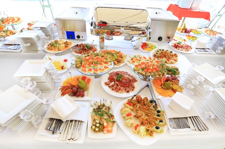 catering table set service with silverware and glass