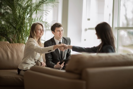 handshake of business partners after discussing a new contract in a modern officeの写真素材