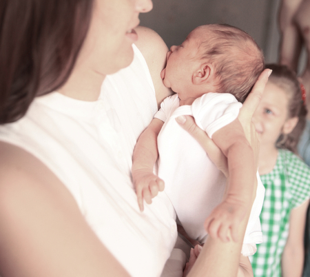 concept of motherhood:a portrait of a young mother with a newborの写真素材