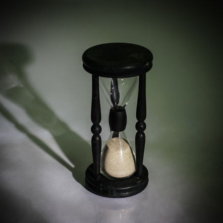 hourglass on dark background.the concept of timeの写真素材