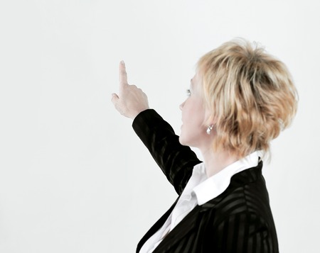 rear view.successful business woman showing at blank screenの写真素材