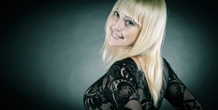portrait of beautiful young woman in evening black dress