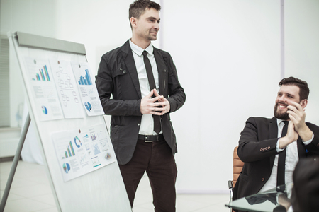 Manager standing next to business project on the presentation of a new financial projectの写真素材