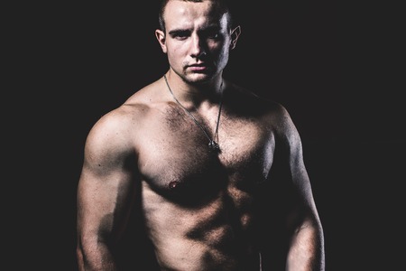 Portrait of a bodybuilder on a black backgroundの写真素材