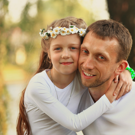 concept of fatherhood - happy father and little daughter huggingの写真素材