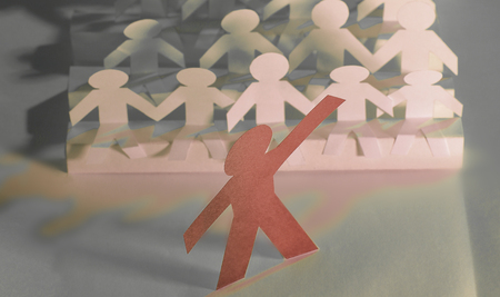 leader standing in front of a group of paper doll.の写真素材