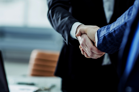 concept of a reliable partnership : a handshake of business partnersの写真素材