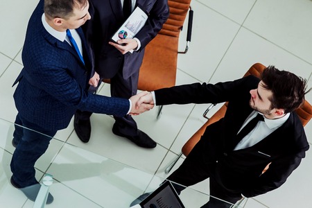 business partners shake hands before starting a business meetingの写真素材