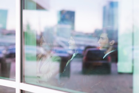 successful business team stands in front of a window in a modern office