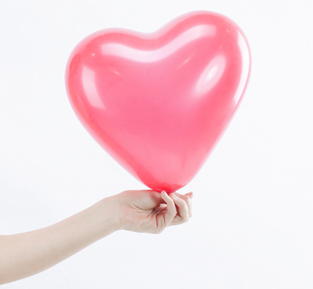 Young woman holding a big red heart.isolated on white.の写真素材