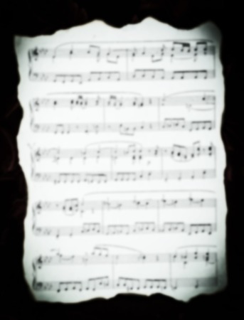 vintage music sheet with burned edges in the blur.の写真素材