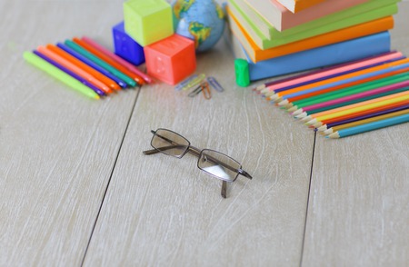 glasses and school supplies on wooden background.photo with copy spaceの写真素材