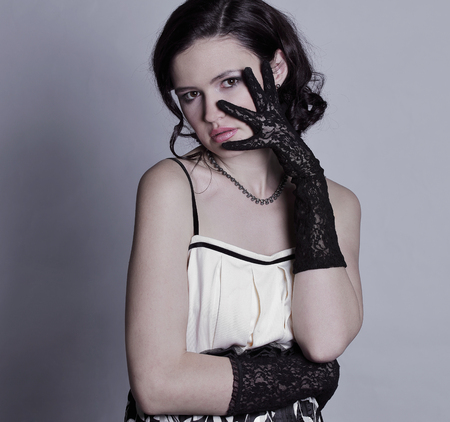 portrait of stylish young woman.isolated on gray backgroundの写真素材