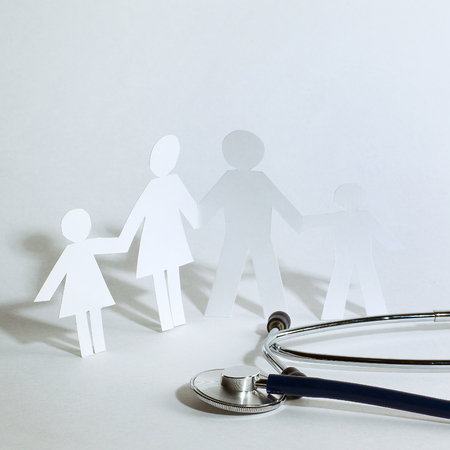 stethoscope and the family paper doll.the concept of health.の写真素材