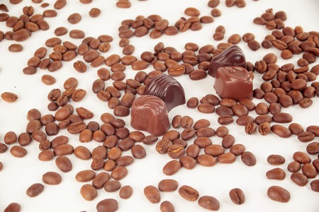 grain black coffee and chocolate candy on a white backgroundの写真素材