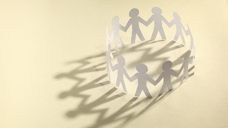 business background.team paper men standing holding hands.の写真素材