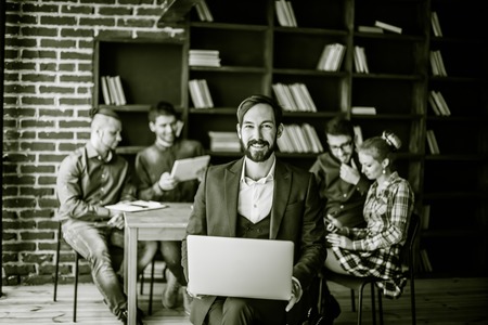 photo in retro style - a sales Manager with a laptop on the backの写真素材