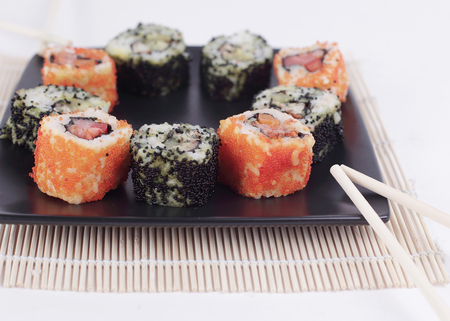 Sushi Set - different types of Maki sushi and chopsticks on a bの写真素材