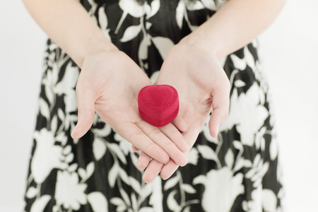 young woman holding gift on Valentines day.
