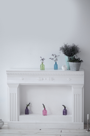 fireplace with decorative ornaments and blank picture on the wall in the living roomの写真素材