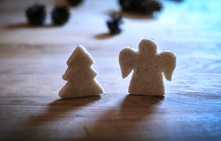 .gingerbread figures Christmas tree and an angel on the wooden tの写真素材