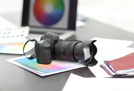camera,fabric samples and sketches are on the desktopの写真素材