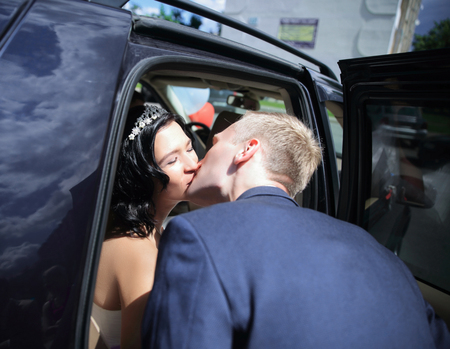 Young couple kissing each other in the car.の写真素材