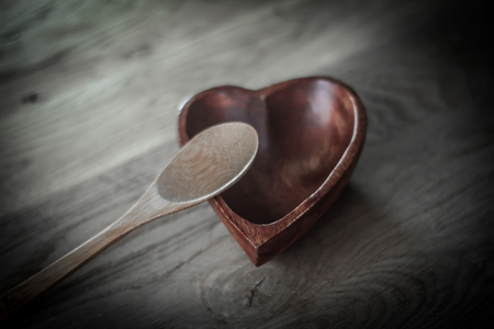 closeup. empty wooden salad bowl and wooden paddleの写真素材