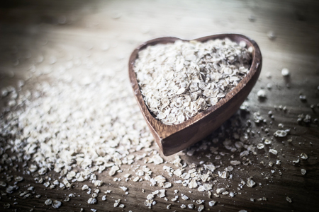 closeup.oat bran cereal on a wooden table.の写真素材