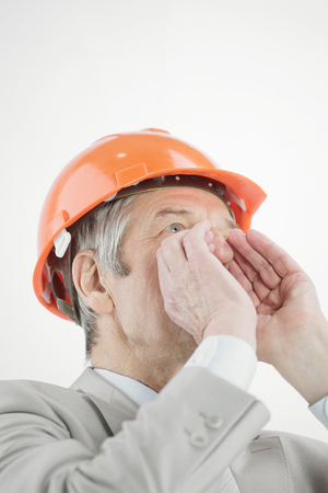 closeup.confident senior engineer shouting .isolated on a whiteの写真素材