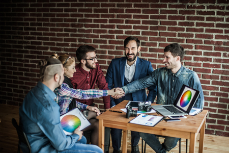 handshake business partners in the workplace in a modern officeの写真素材
