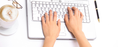 closeup.young woman typing text on laptop keyboardの写真素材