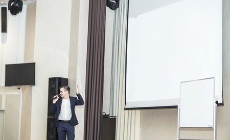 Speaker conducts the business of the conference in the modern conference room