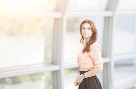 modern business woman standing near a large window in the office.の写真素材