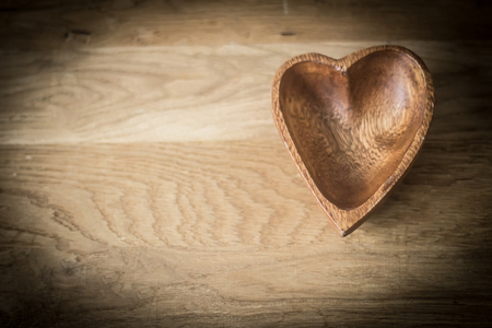 wooden salad bowl in the shape of heartの写真素材