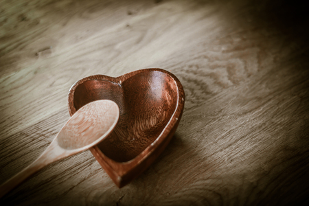 closeup. empty wooden salad bowl and wooden paddleの写真素材