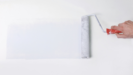closeup.businessman drawing a paint roller on the wall.の写真素材