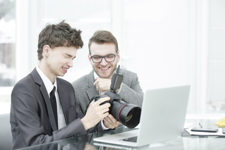 qualified photographers choose photos to upload files to their laptops