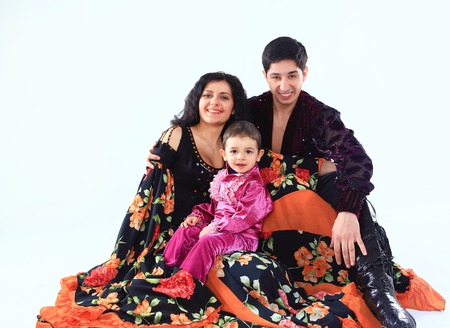 portrait of a happy Gypsy family: father, mother and son in national costumesの写真素材