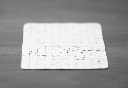 blank card collected from puzzle pieces on wooden backgroundの写真素材
