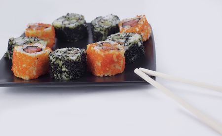 Sushi Set - different types of Maki sushi on a black plate.の写真素材
