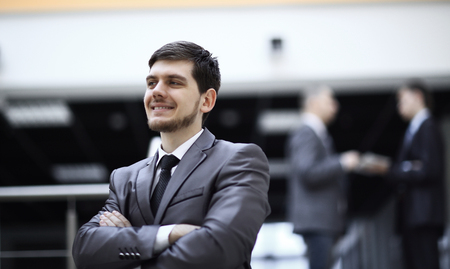 portrait of handsome businessman on blurred office backgroundの写真素材