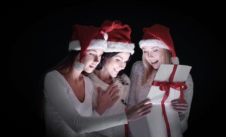 group of female students in costumes of Santa Claus opening a bの写真素材