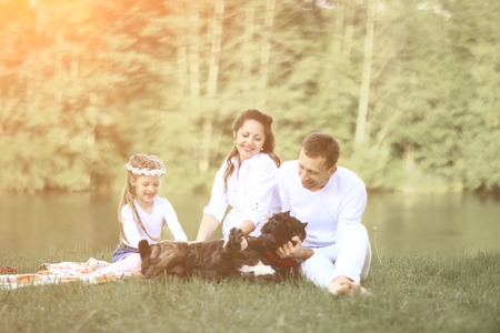 happy family with pet dog at picnic in a Sunny summer day. pregnの写真素材