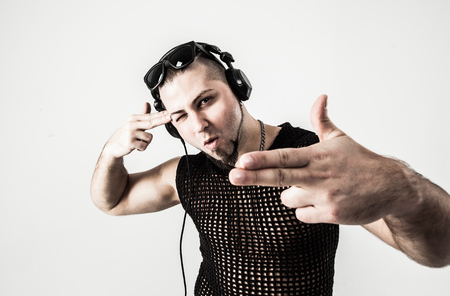 portrait of a DJ in a stylish t-shirt with headphones on a whiteの写真素材