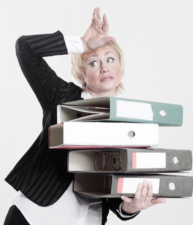 astonished business woman with stack of documentsの写真素材