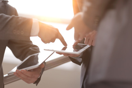 close up.two businessmen with tablet computersの写真素材