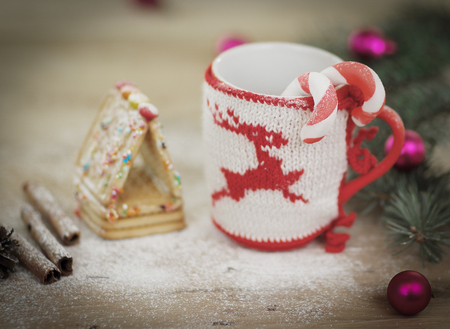 Christmas Cup ornament and sweets on wooden background.の写真素材