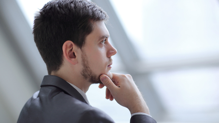 close up.Businessman looking through his office windowの写真素材